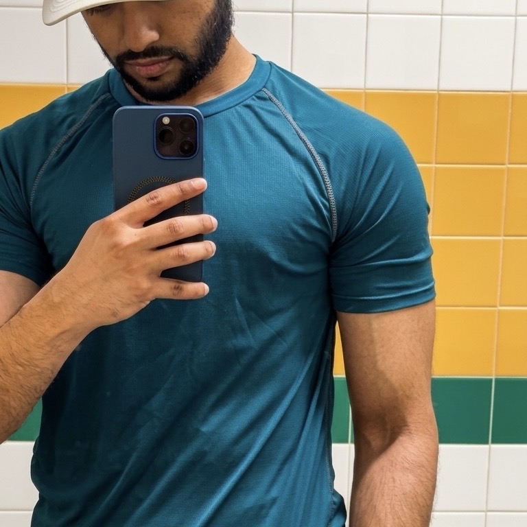Mirror shot at the gym, mid-session in a training tee